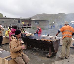 A group of people having a BBQ