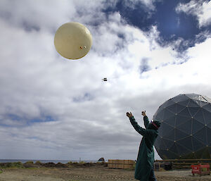 A person releasing a weather balloon