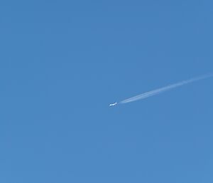 A plane flying in a blue sky