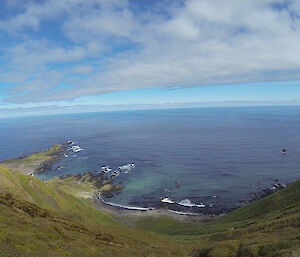 A vista of Hurd Point, green the foreground with blue sky