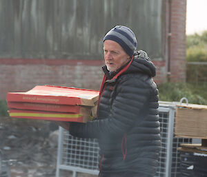 A man with pizza boxes