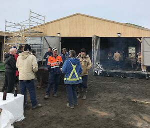 People standing around in front of the new boatshed
