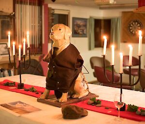 A dog statue dressed up on a table