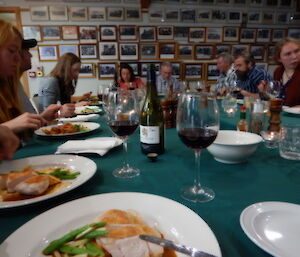 A group of people eating a dinner around a large table