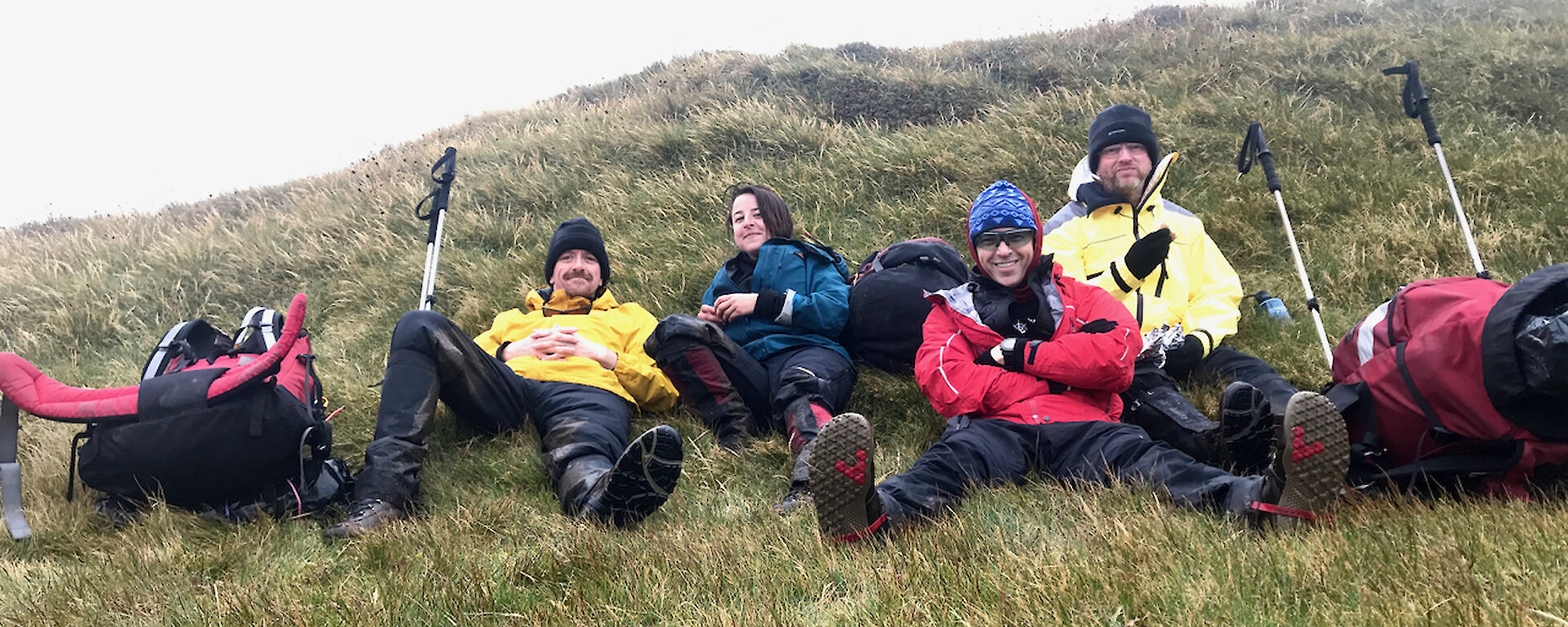 Macquarie Island expeditioners taking a break on the grass and enjoying field training