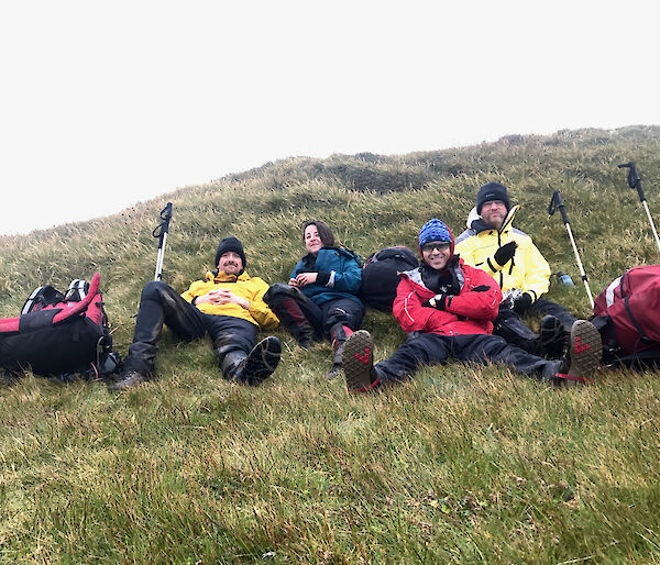 Macquarie Island expeditioners taking a break on the grass and enjoying field training