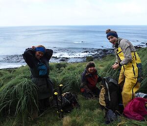 Three expeditioners preparing to take on the Lusitania Bay slopes — Macquarie Island