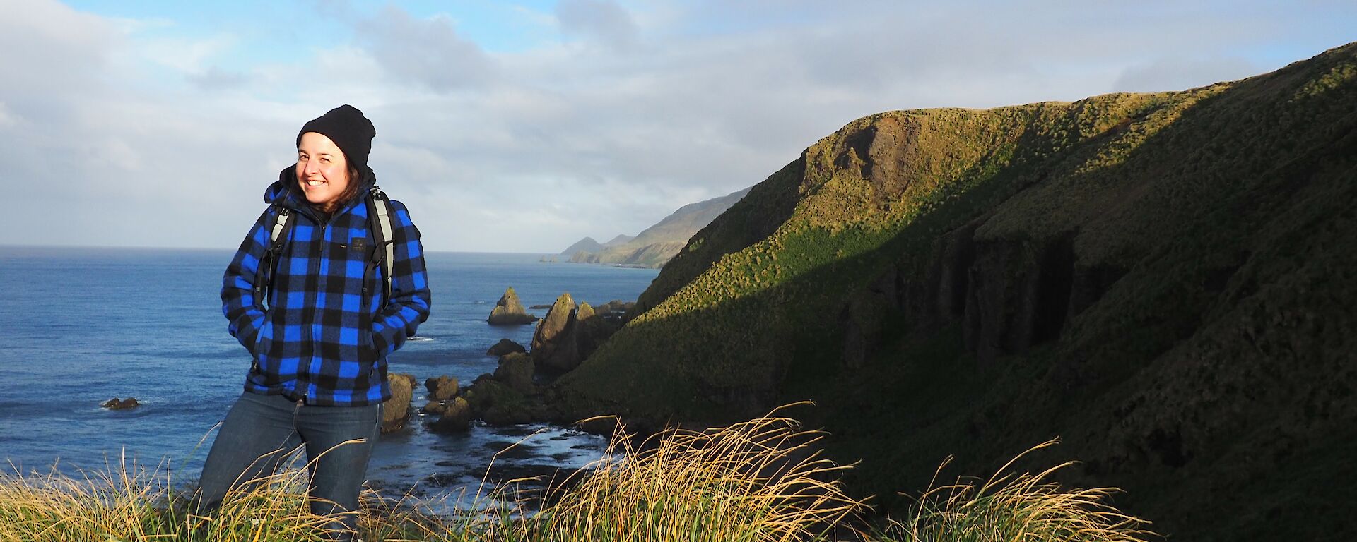 Andrea standing on the hill top at Secluded Bay — Macquarie Island