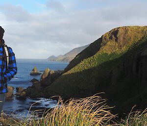 Andrea standing on the hill top at Secluded Bay — Macquarie Island