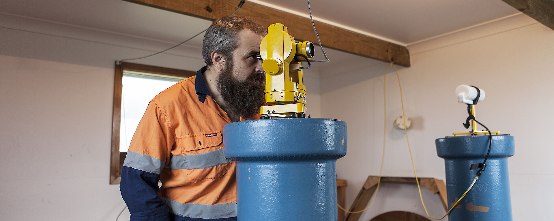 Man looking through an instrument to take magnetic observations