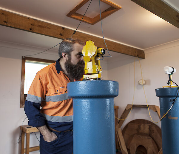 Man looking through an instrument to take magnetic observations