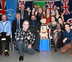 A group photo of all the expeditioners inside and wearing nice clothes.