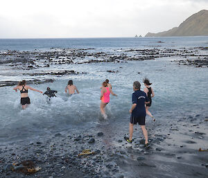 The expeditioners running into the water.