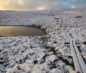 The flat and frozen ground with a lake and the overland track.