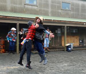 Two men jumping up and chest bumping like elephant seals.