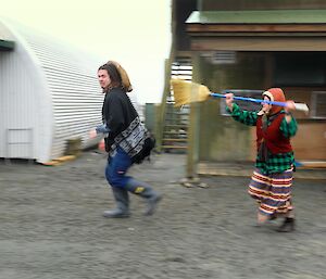 The final scene of the short film, an old looking lady chasing the villain down the road with a broom.