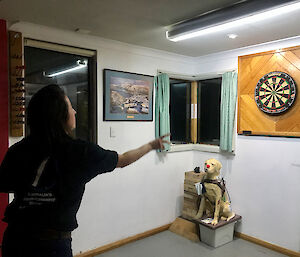 A woman throwing a dart at the board.