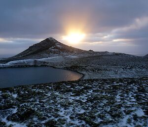 Sunset over Windy Ridge, with water in the foreground.