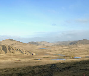 On the Overland Track looking south to Green Gorge showing a great expanse of green vegetation and hills.