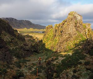 The Labyrinth. An expeditioner walking in the distance with high rugged hill peaks.