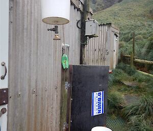 A bucket hanging outside is used as a shower.