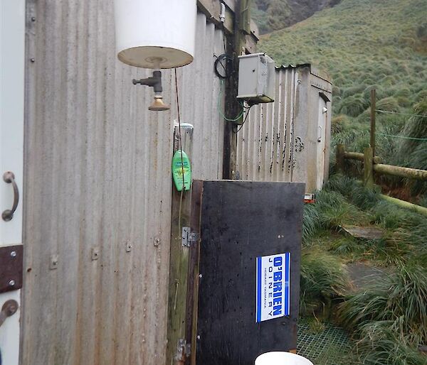 A bucket hanging outside is used as a shower.