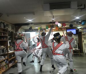 Expeditioners dressed as Morris dancers and performing for chef Nick’s birthday.