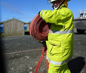 Macquarie Island fire team member Geoff Wallace prepares to roll out the hoses