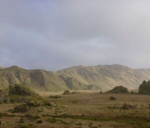 A landscape photo of hills with grey skies.