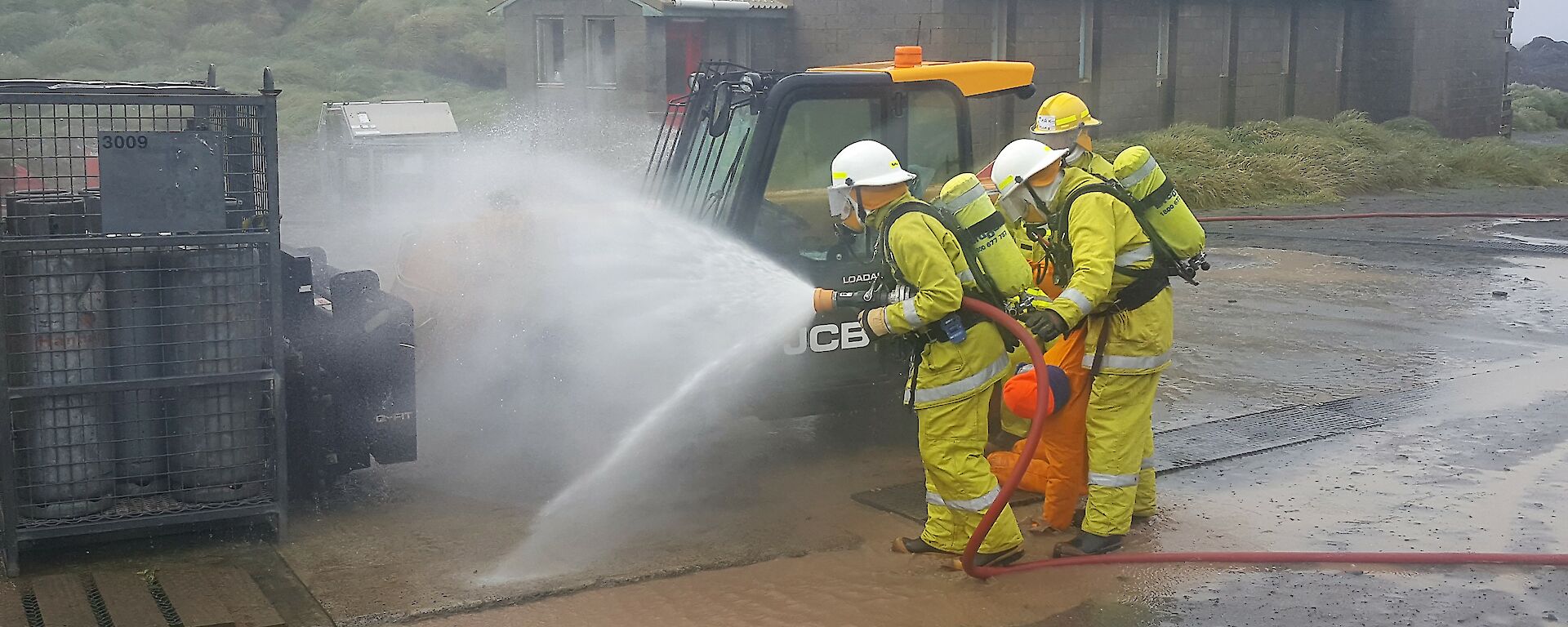 Macca fire team members combat a simulated LPG fire.