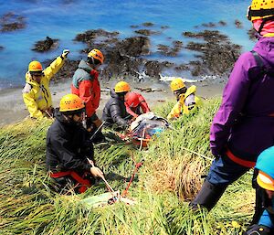 The stretcher being prepared to be lowered down the slope by the rope rescue team.