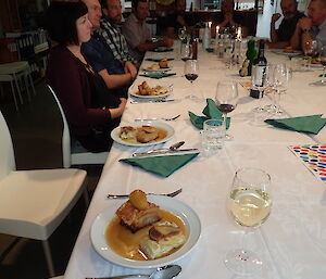 Expeditioners at a set table dining over Easter at Macquarie Island