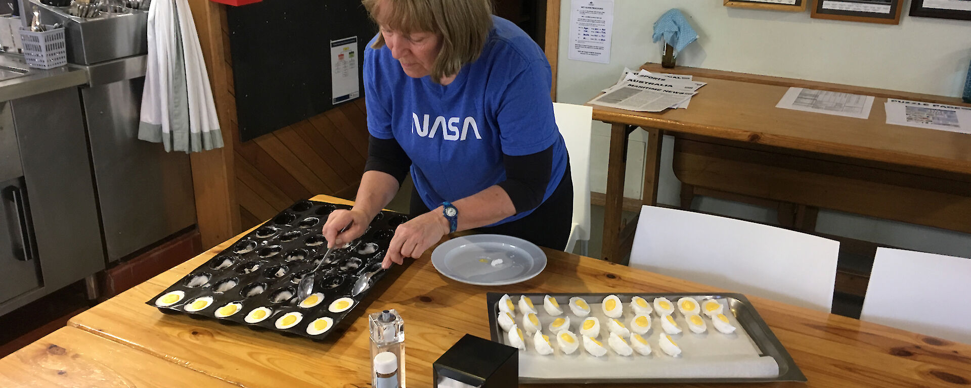 Ali Dean is removing marshmallow eggs from a silicon mold in preparation for Easter at Macquarie Island