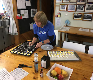 Ali Dean is removing marshmallow eggs from a silicon mold in preparation for Easter at Macquarie Island