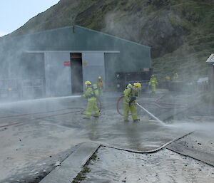 Two members of the Fire Team practice with hoses at Macquarie Island recently