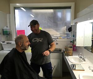Norbert Trupp ready with cape to have his hair cut by our volunteer hairdresser Tim Kerr