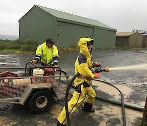 Station Fire Chief Danielle McCarthy opens up the fire hose attached to our auxiliary fire response pump at Macca