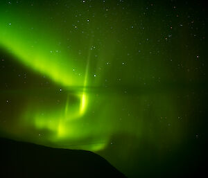 Clear bright green curtains of aurora in the night sky above Macquarie Island this week