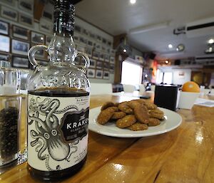 A plate of ANZAC biscuits with a bottle of spiced rum — part of our Gunfire Smoko on ANZAC Day at Macquaire Island this week
