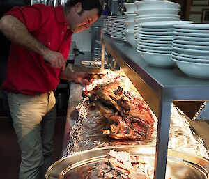 Chris Burns carving up the spit roast on ANZAC Day at Macquarie Island