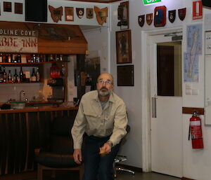 Norbert Trupp throws two coins into the air from the Kip during a game of two-up on ANZAC Day, Macquaire Island