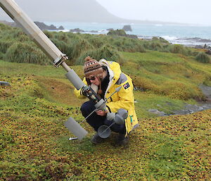 Angus Cummings working on the anemometer at the head of the tilted mast at Macquaire Island