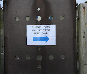 A notice for elephant seals on a fence at Macca