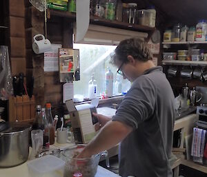 Angus Cummings making bread at Green Gorge hut, Macquarie Island