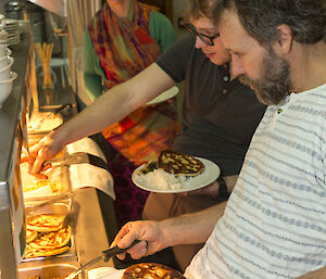 Greg, Angus and Danielle at the Bain Marie, Macca deciding what curry to have