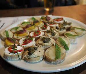 A plate full of canapes colourfully decorated