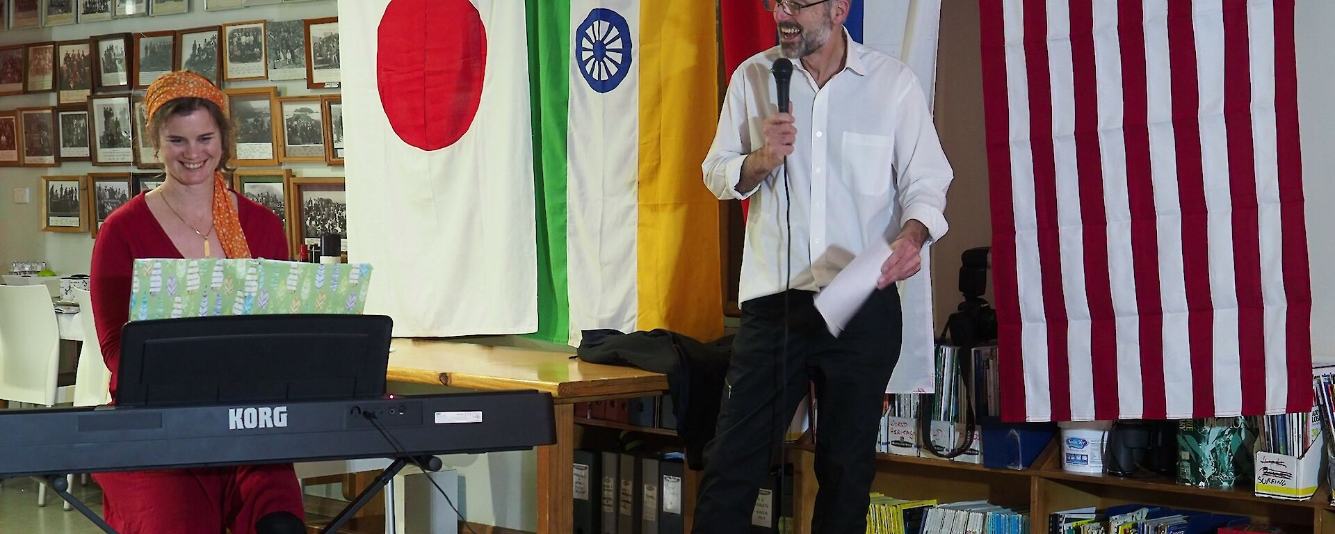 Danielle playing the electric piano with Norbert singing in the flag lined mess at Macca for Midwinter 2018