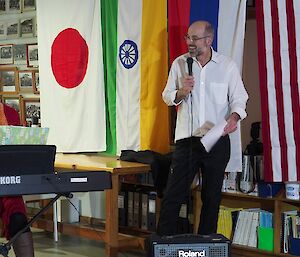 Danielle playing the electric piano with Norbert singing in the flag lined mess at Macca for Midwinter 2018