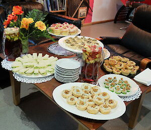A table laind out with dishes full of food for the summer soiree held at Macca
