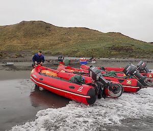 Inflatable Rubber Boats IRBs hauled up on the beach at Bauer Bay as we resupply the hut with food, gas and medical supplies